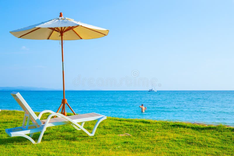 Beach Chairs and Beach Umbrellas are on the Lawn at the Beach.Sea View
