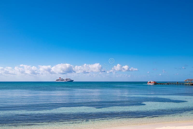 Small cruise ship on the sea in the Caribbean drops passengers on the island with a tender boat, Isla de la Juventud, Cuba