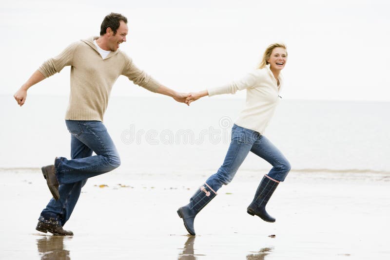 beach couple hands holding running beach couple hands holding running