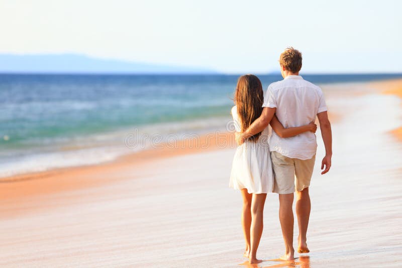 Beach couple walking on romantic travel