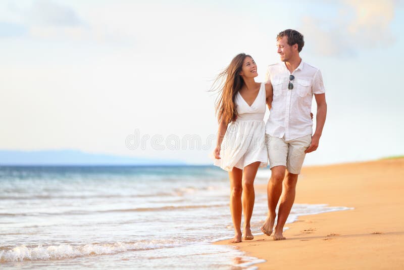 Beach couple walking on romantic travel