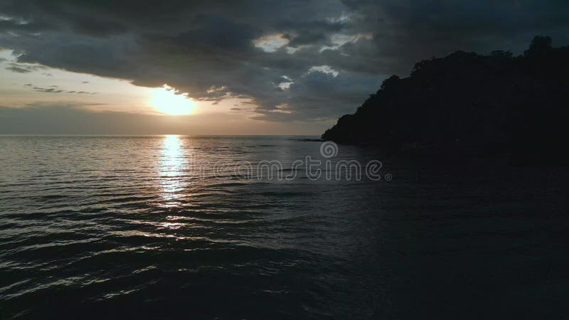 Beach in evening, headland jungle sunset dark. Gorgeous aerial view flight drone