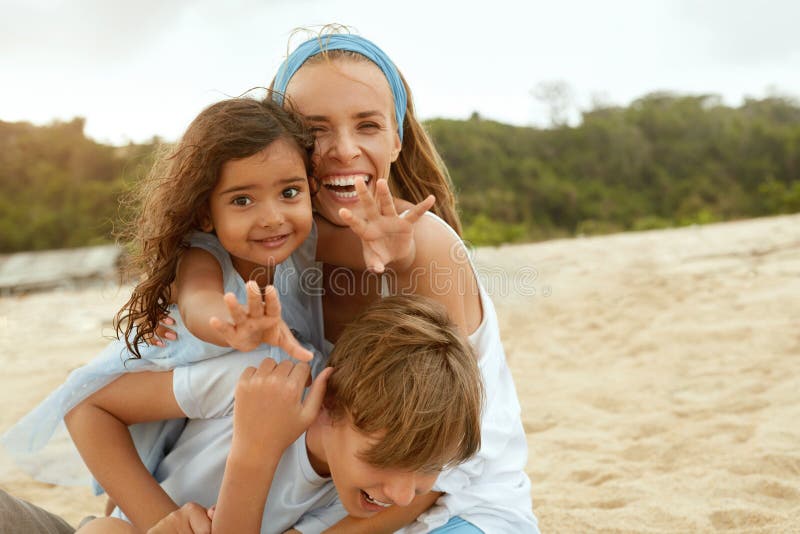 Beach. Family Portrait Of Happy Mother, Son And Daughter. Young Woman In Fashion Dress With Little Girl And Boy.