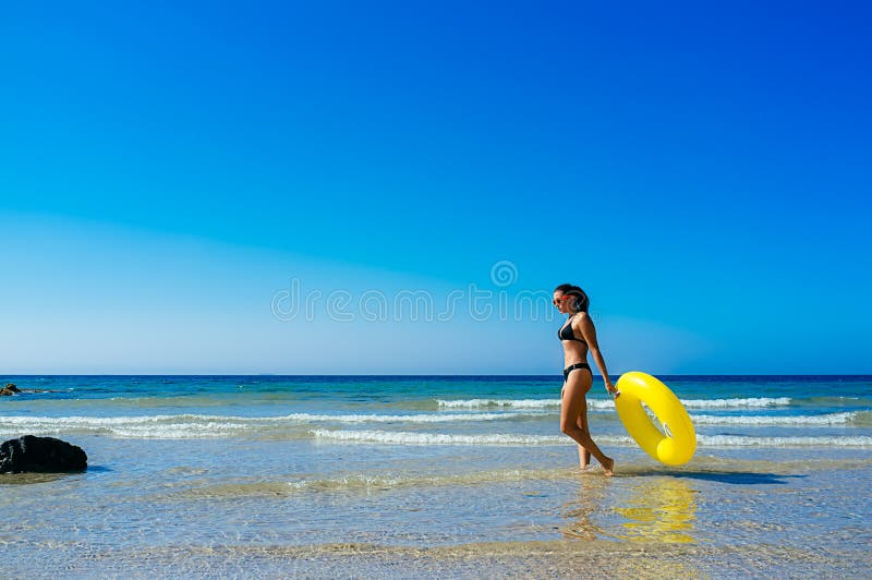 Beach Girl Walking Along the Seashore in Cadiz