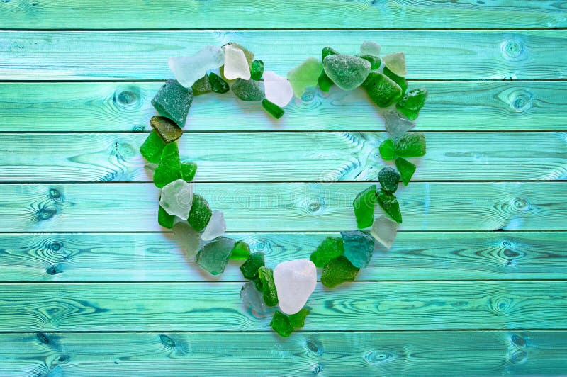 Beach glass collection in the shape of a heart on blue planks royalty free stock photos Beach glass collection in the shape of a heart on blue planks royalty free stock photos