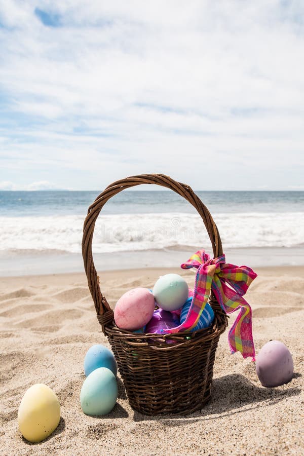 Beach Happy Easter Background with Basket and Color Eggs Stock Photo