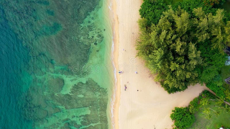 A beach of Hawaii with a white boat. Aerian view of a beach of Hawaii with a white boat