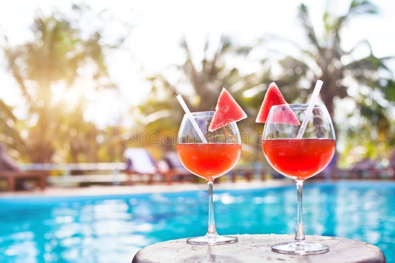 Beach holidays background with two cocktails near swimming pool in luxurious hotel