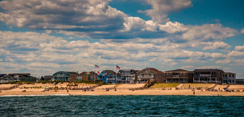 Beach houses and people on the beach in Point Pleasant, New Jersey.