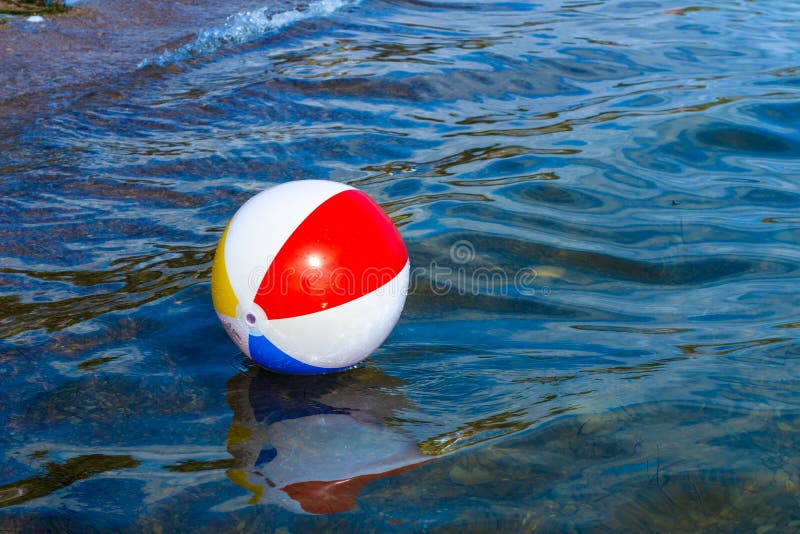 Beach inflatable ball floating in the water. 