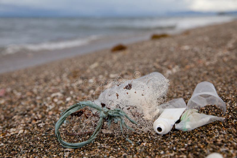 Beach Pollution. Plastic Bottles and Other Trash on Sea Beach Stock