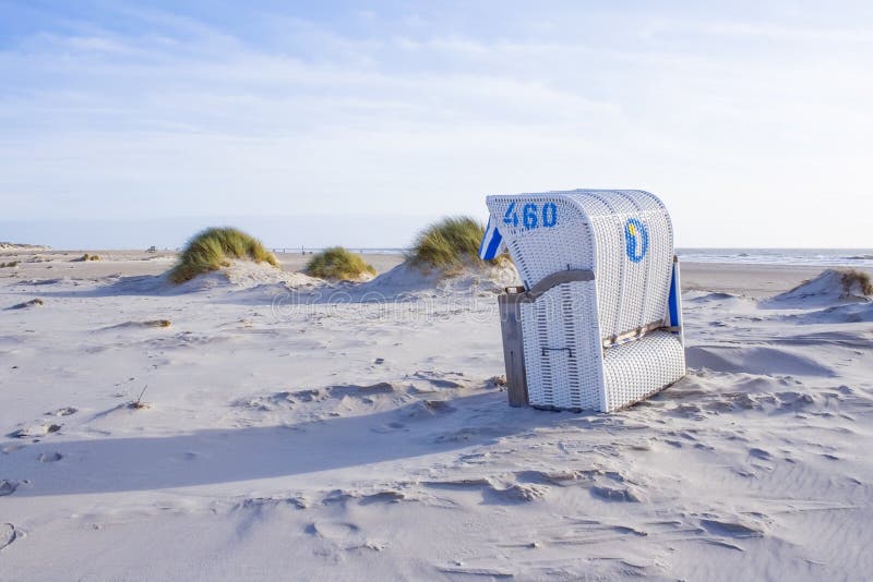 Beach scene with beach chair on the island `Amrum`, North Sea, Germany.