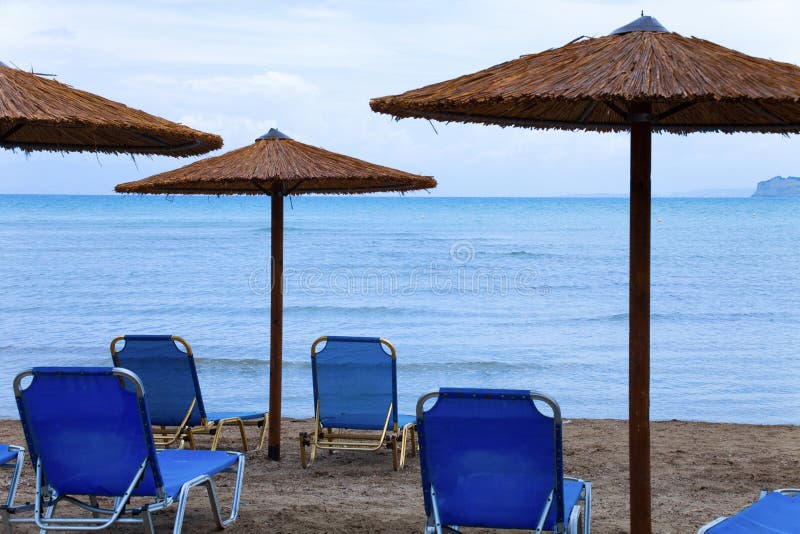 Beach at sea with canyon and sandy beach. Plastic seats on the sandy beach. Holiday concept with beach and sea in the stock image Beach at sea with canyon and sandy beach. Plastic seats on the sandy beach. Holiday concept with beach and sea in the stock image
