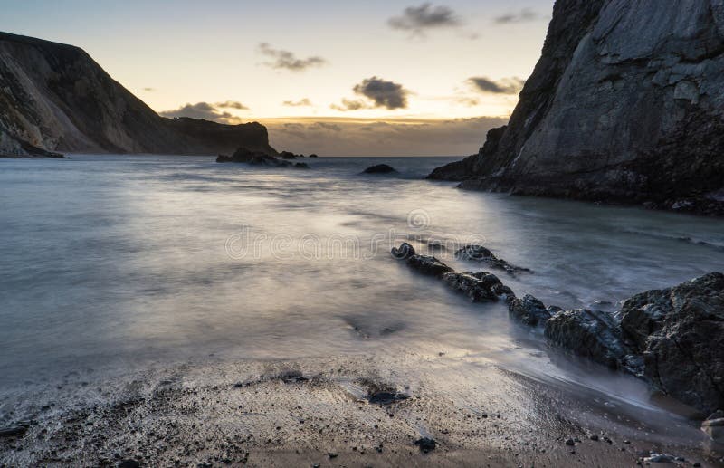 Beach Sunrise Landscape with Long Exposure Waves Movement Stock Photo