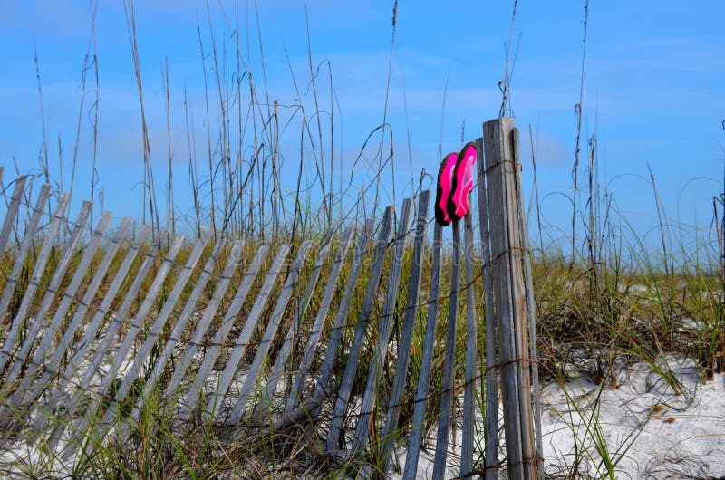 Beach swim shoes drying on fence at Florida beaches