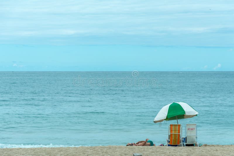 Beach Tent Umbrella A Person And Two Chairs On The Armacao Be