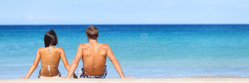 Beach travel banner - romantic couple relaxing royalty free stock image