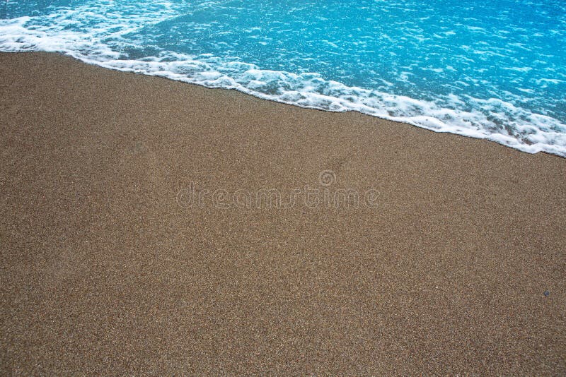 Beach tropical shore with brown sand and clear water wave. Beach tropical shore with brown sand and clear water wave