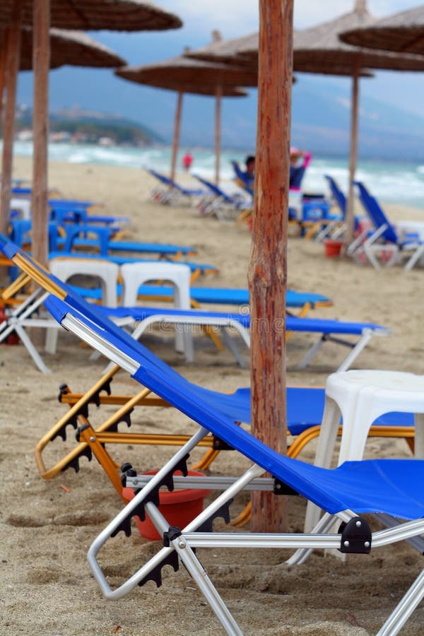 Sun Umbrella and Beds on Caribbean Beach in Cloudy Weather Stock Photo