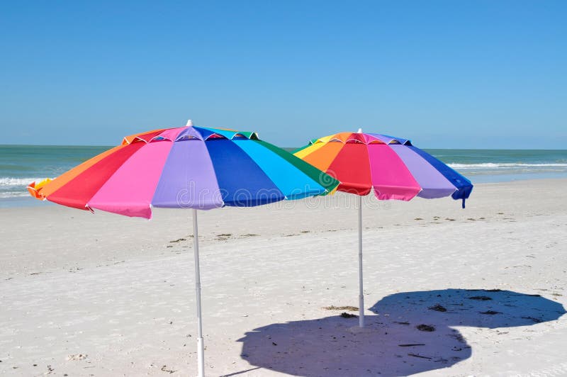 Bright Colored Beach Umbrella on a Sunny Beach Day. Stock Photo Image