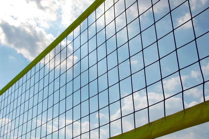 Beach volley net in front of cloudy sky