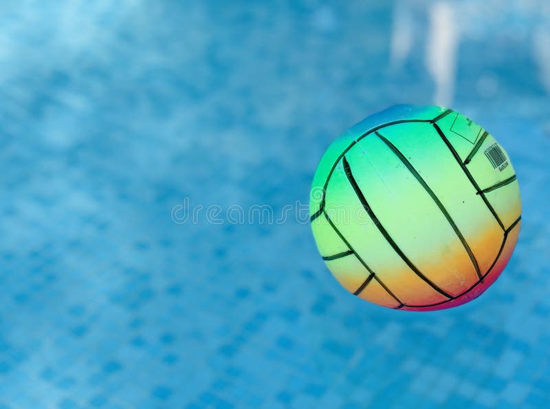 Beach Volleyball Ball Floating in Swimming Pool. Copy Space Stock Photo