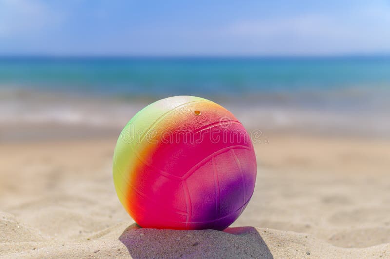 Beach Volleyball Ball in the Foreground on the Sand Beach Stock Image