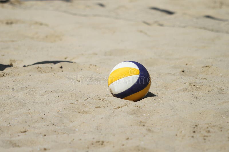A beach volleyball ball over sand court