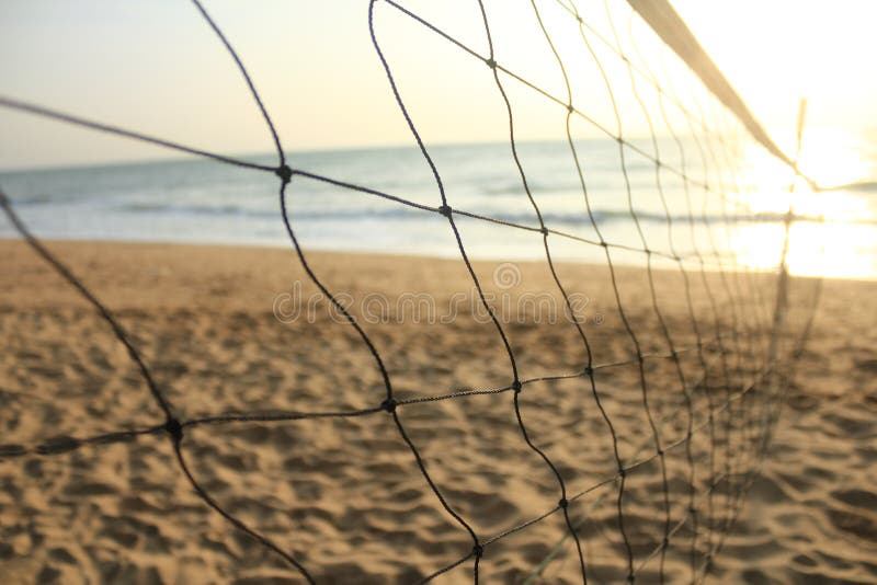 Sunset sea sand and beach volleyball net