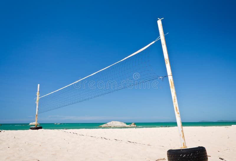 A beach volleyball net on a sunny day with blue sky