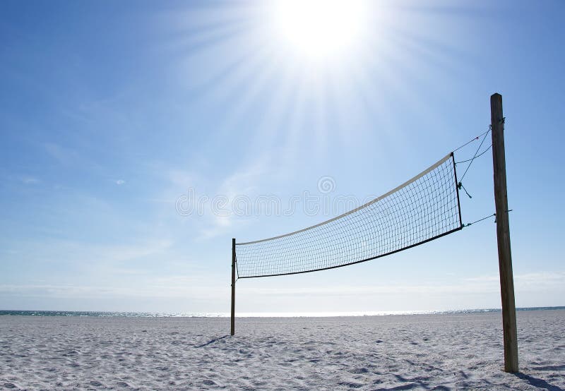 A beach volleyball net on a sunny day, on an empty beach