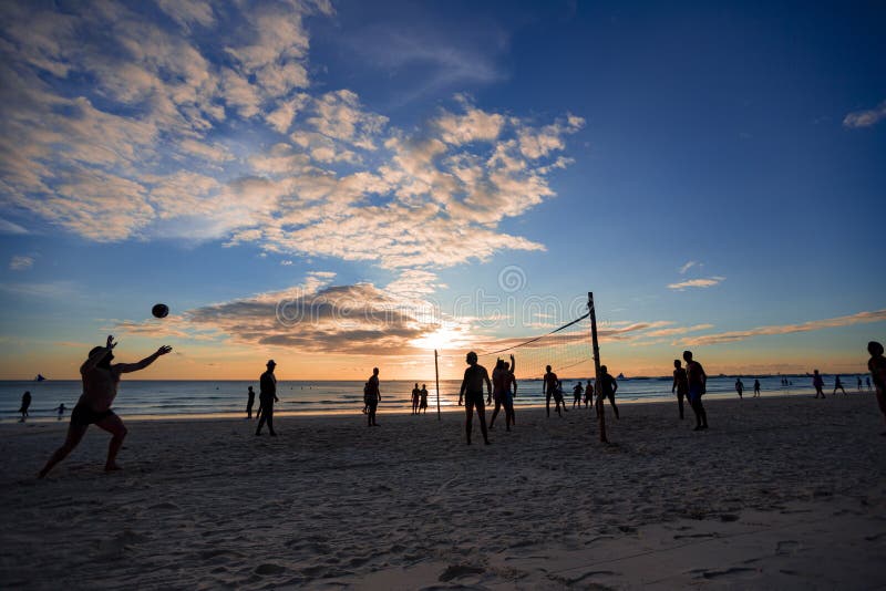 Beach Volleyball at sunset editorial stock photo. Image of activity