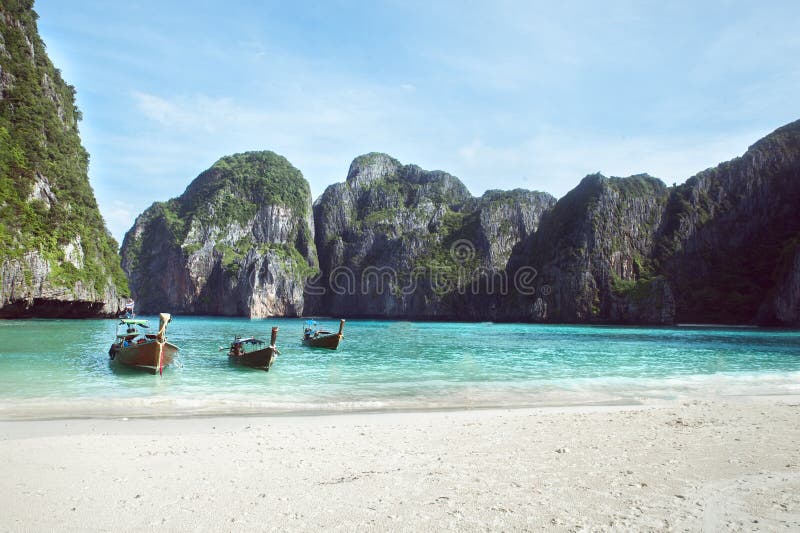 Beach with white sand landscape. Boat mooring in Asian style, canoe.