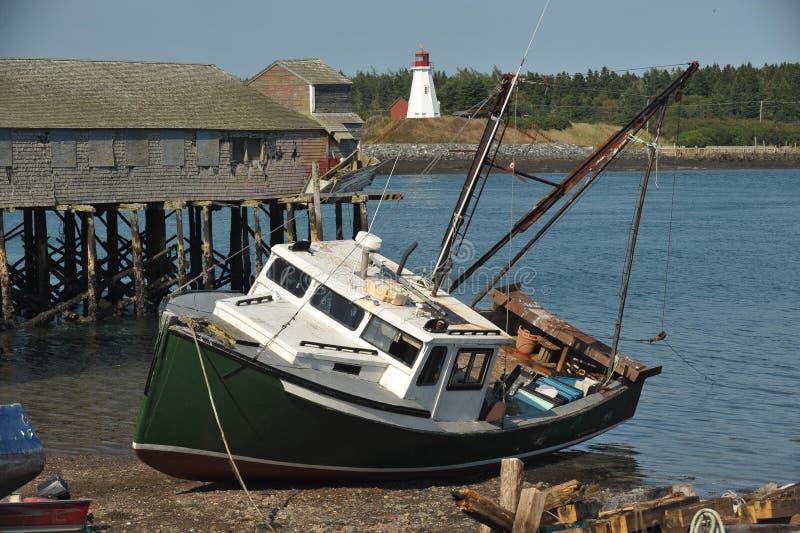 Beached Fishing trawlers with abandoned docks stock images