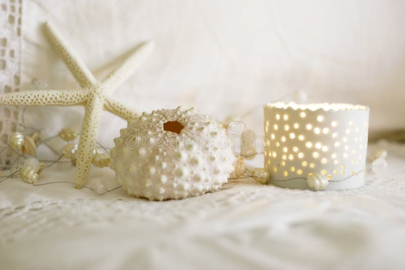Beachside dream. Shells and candle on beding Beachside dream. Shells and candle on beding