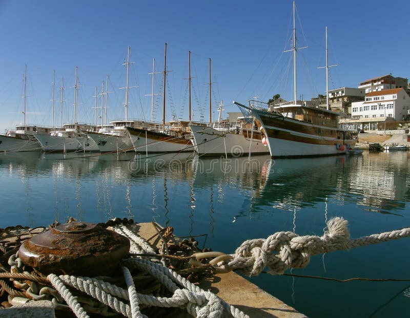 Beacon, ropes and boats in the harbor