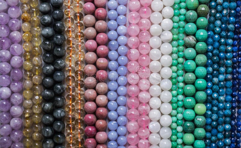 Beads from various types of natural stones are strung on a thread