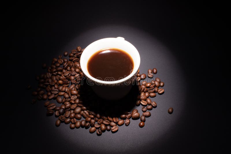 Beam of Light on Protein Coffee Bucket with a Drink in Coffee Beans on a Dark Background Stock
