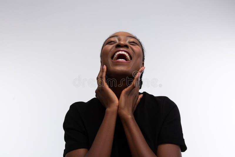 Beaming cute African-American woman laughing out loud stock photos Beaming cute African-American woman laughing out loud stock photos