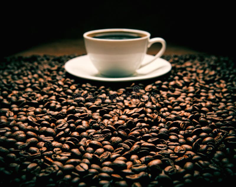 Beans with cup of coffee stock image