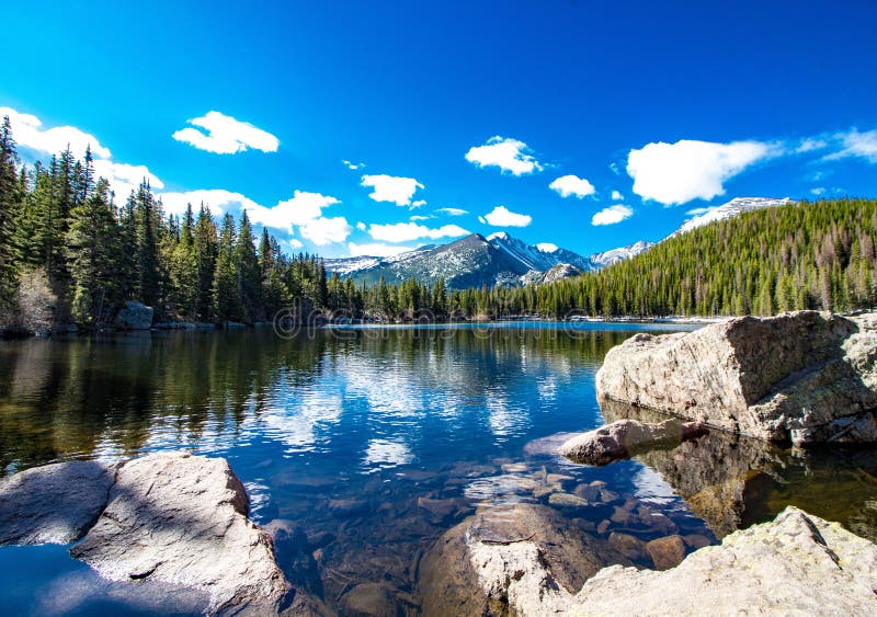 Bear Lake at Rocky Mountain National Park in Colorado in the Spring. Beautiful morning, white clouds and blue skies. Bear Lake at Rocky Mountain National Park in Colorado in the Spring. Beautiful morning, white clouds and blue skies.