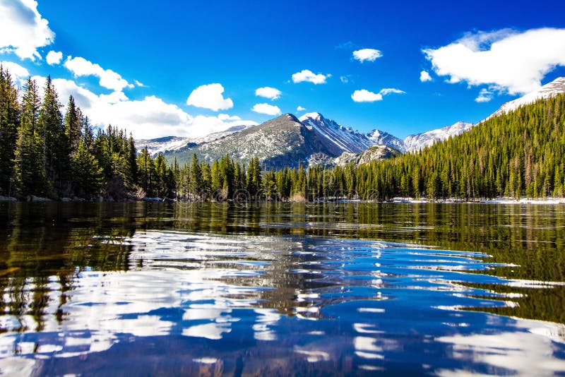 Bear Lake at Rocky Mountain National Park in Colorado in the Spring. Beautiful morning, white clouds and blue skies. Bear Lake at Rocky Mountain National Park in Colorado in the Spring. Beautiful morning, white clouds and blue skies.