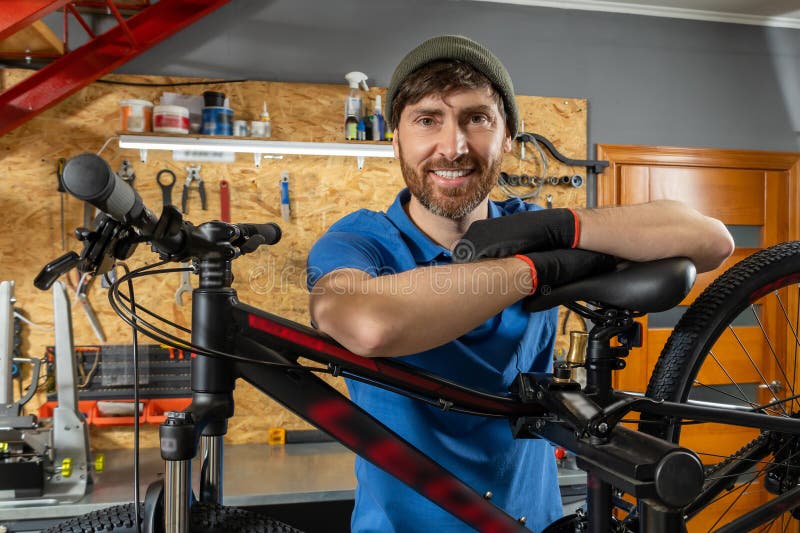 Bearded bike repair specialist working in organized workshop royalty free stock image