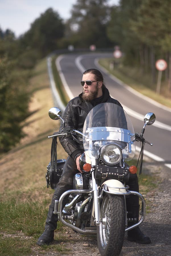 Bearded Biker with Long Hair in Black Leather Jacket Sitting on Modern Motorcycle. Stock Image - Image of landscape, male: 167858177 Bearded Biker with Long Hair in Black Leather Jacket Sitting on Modern Motorcycle. Stock Image - Image of landscape, male: 167858177