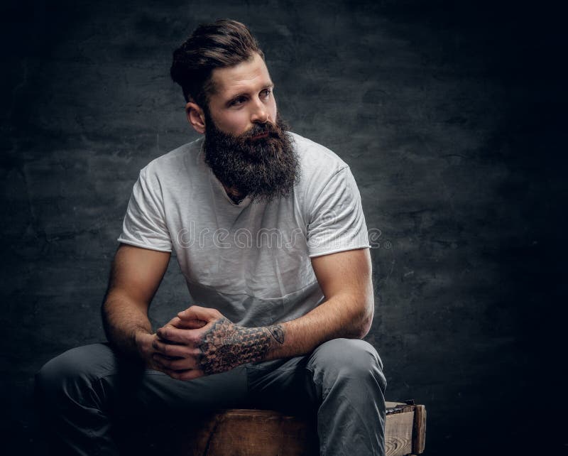 Bearded Male with Tattoo on Arm Dressed in a White T Shirt Sits Stock Image  - Image of haircut, uniformity: 109981861