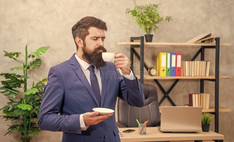 Bearded businessman enjoy coffee in the office with copy space, guy stock images