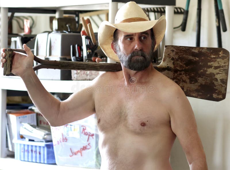 A Bearded Cowboy Puttering in His Tool Shed royalty free stock image A Bearded Cowboy Puttering in His Tool Shed royalty free stock image