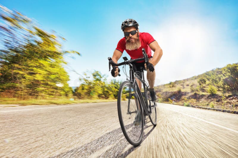 Cyclist with Helmet and Sunglasses Riding a Road Bicycle and Looking ...