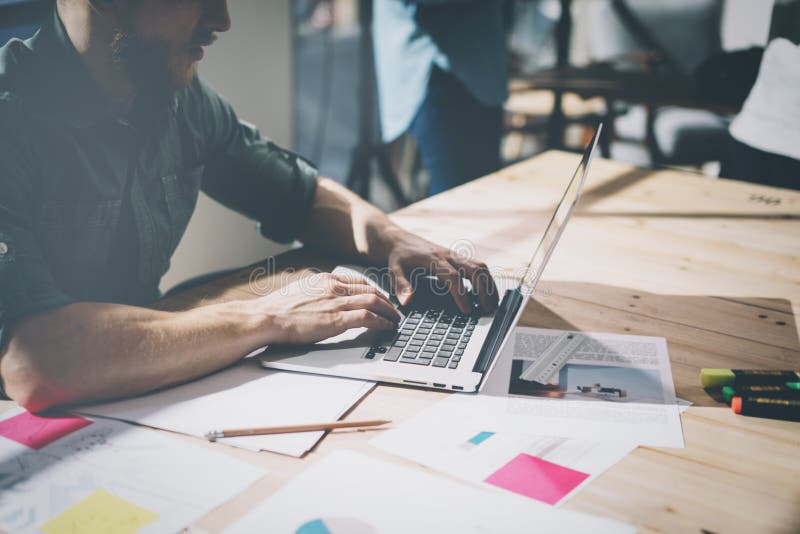 Bearded businessman working with team new project. Generic design notebook on wood table. Bearded businessman working with team new project. Generic design notebook on wood table