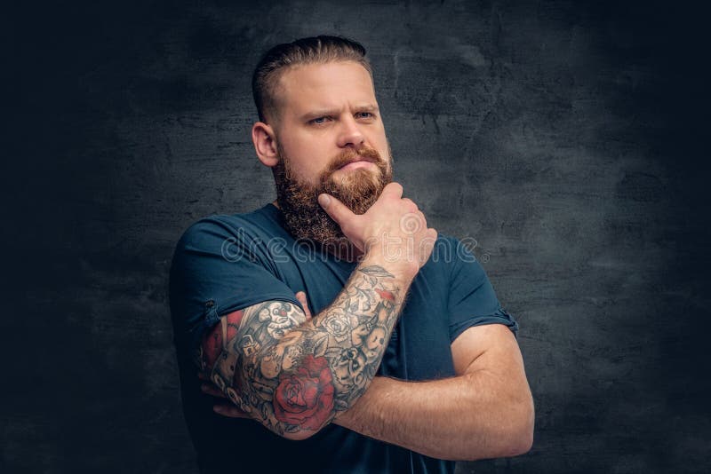 Free Photo  Bearded fat male with tattoo on arms posing over grey  background